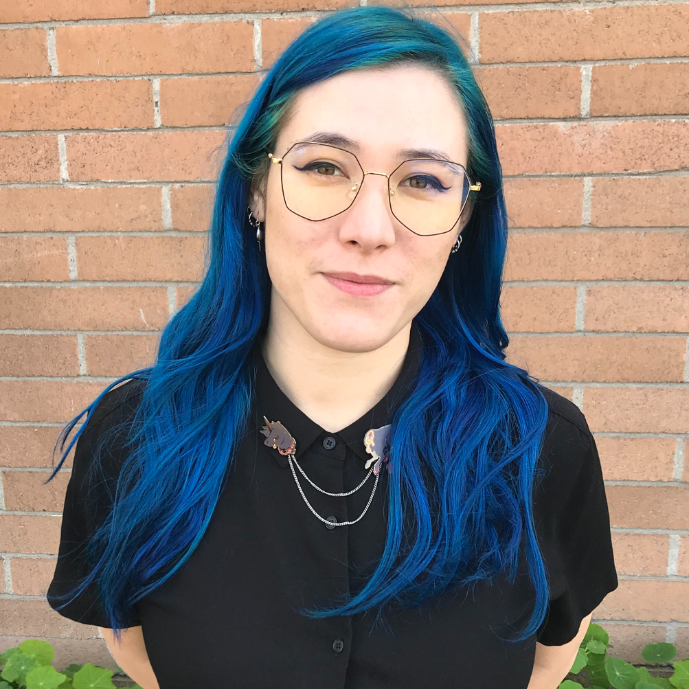 Photo of Maeve MacLysaght, an agent with Copps Literary Services. She represents BIPOC, Queer, and marginalized creators writing commercial genre fiction across MG, YA, Adult, and Graphic Novel. Her particular weaknesses are genre-blending SFF, horror, and anything with murder or making out (ideally both). Her clients include Emily Ettlinger (Skeleanor the Decomposer, Penguin Workshop 2024) and Sami Ellis (Dead Girls Walking, Amulet 2024). Find her online: https://www.emlysaght.com/ or https://twitter.com/mmmlysaght